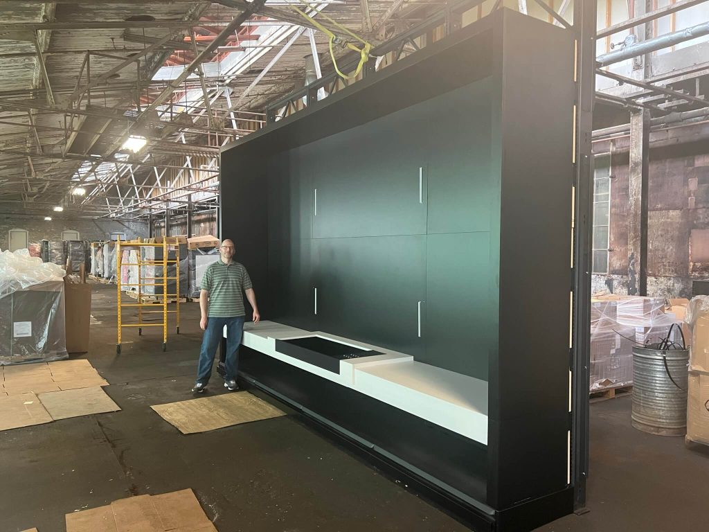 Twelve-foot media display backwall standing in the production warehouse